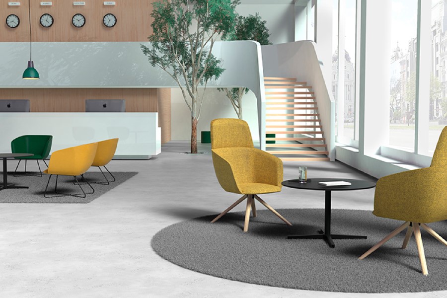 Zona de soft seating en espacios de trabajo con butacas y sillones de vivos colores 